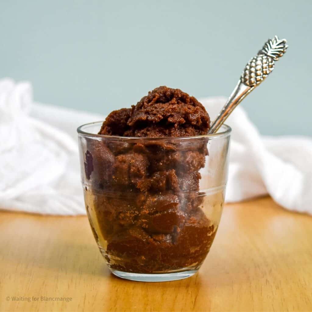 Glass of rich edible chocolate brownie dough.