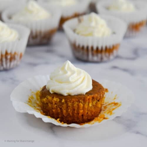 Close up of mini pumpkin pies with vanilla whipped cream.